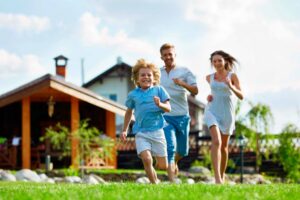 Family running out of a cabin-style vacation rental house